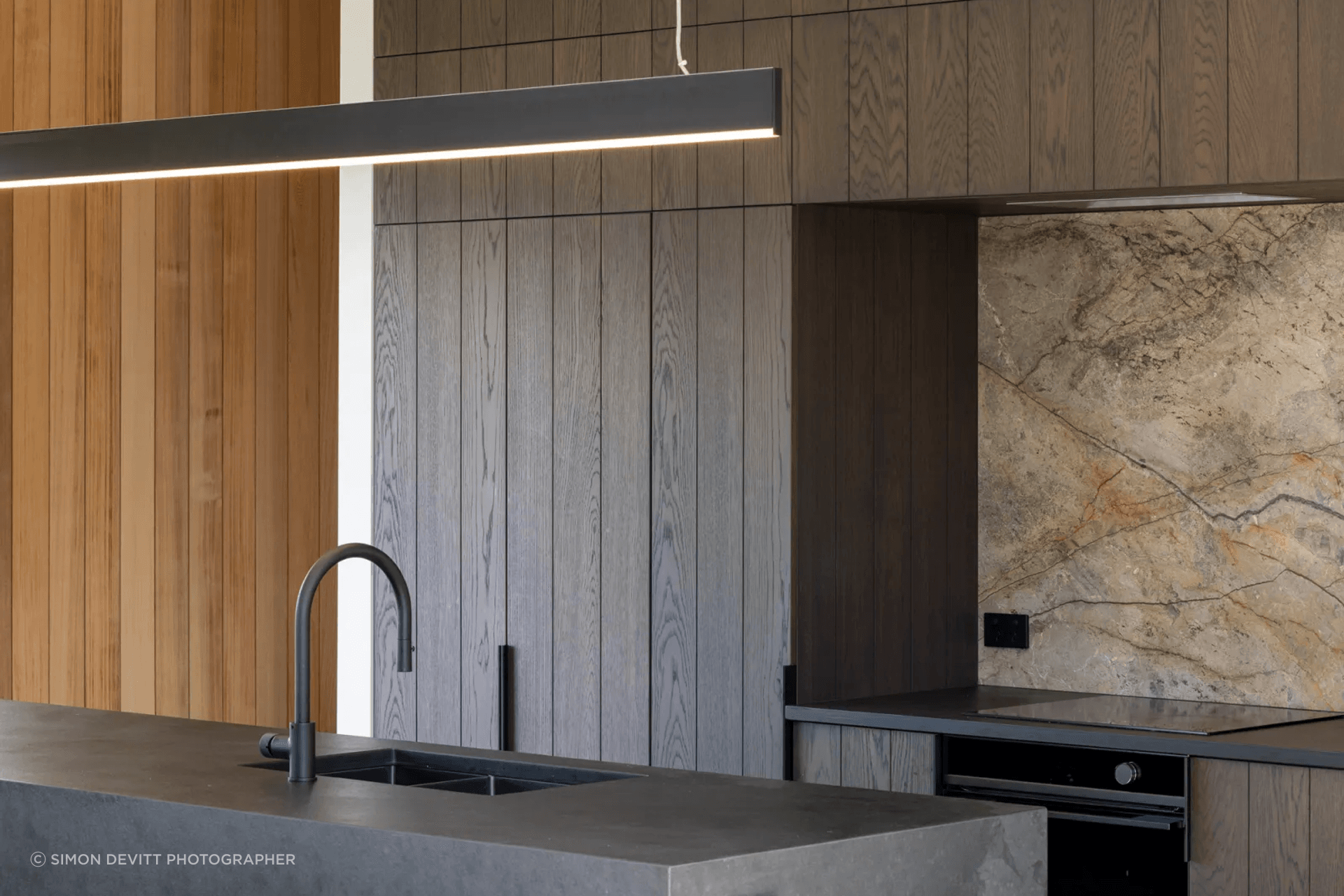 DBJ’s craftsmanship can be appreciated throughout the home, and specifically in the kitchen, where the dark chocolate brown cabinetry is more a piece of art.