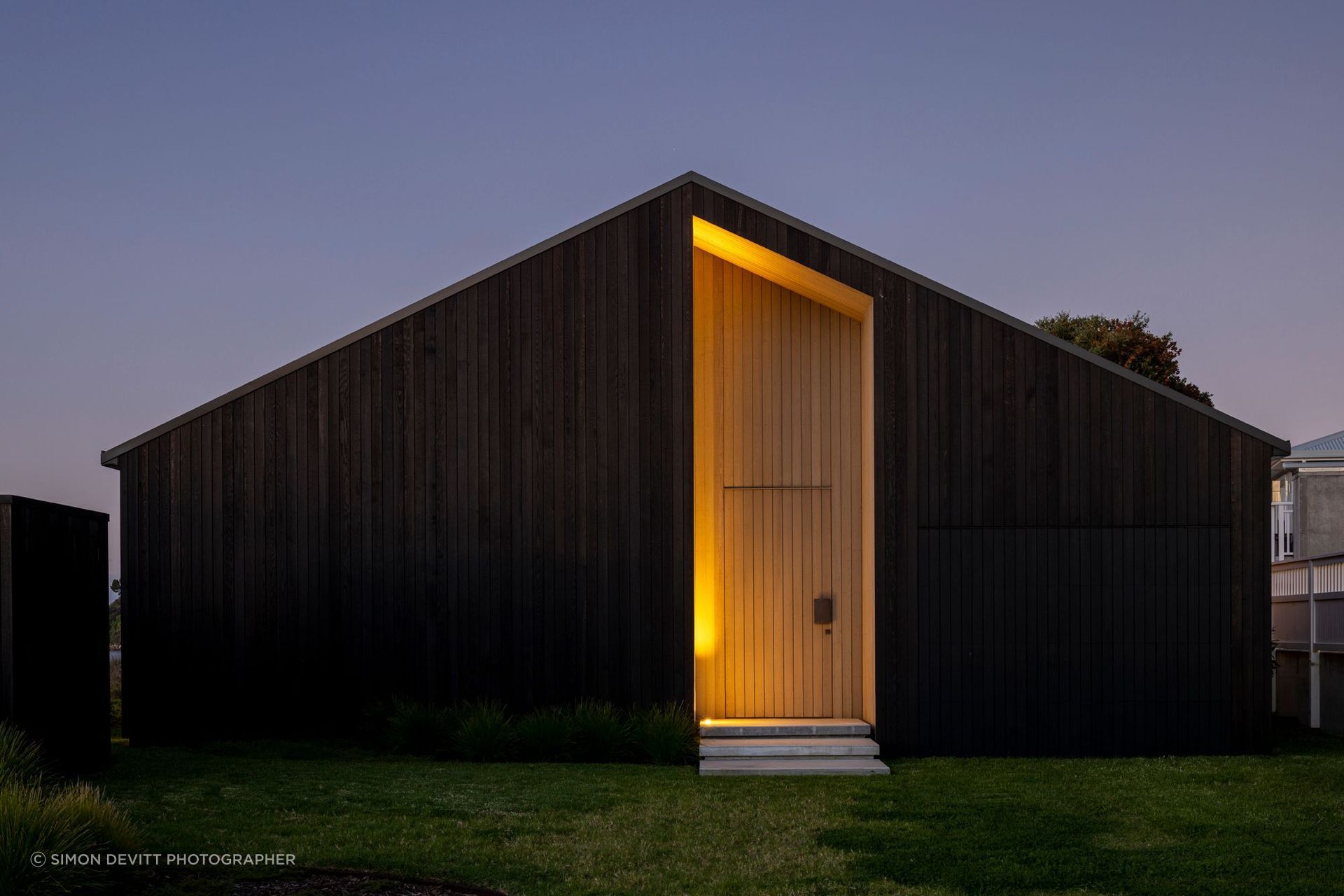The darkly clad street elevation has no windows.