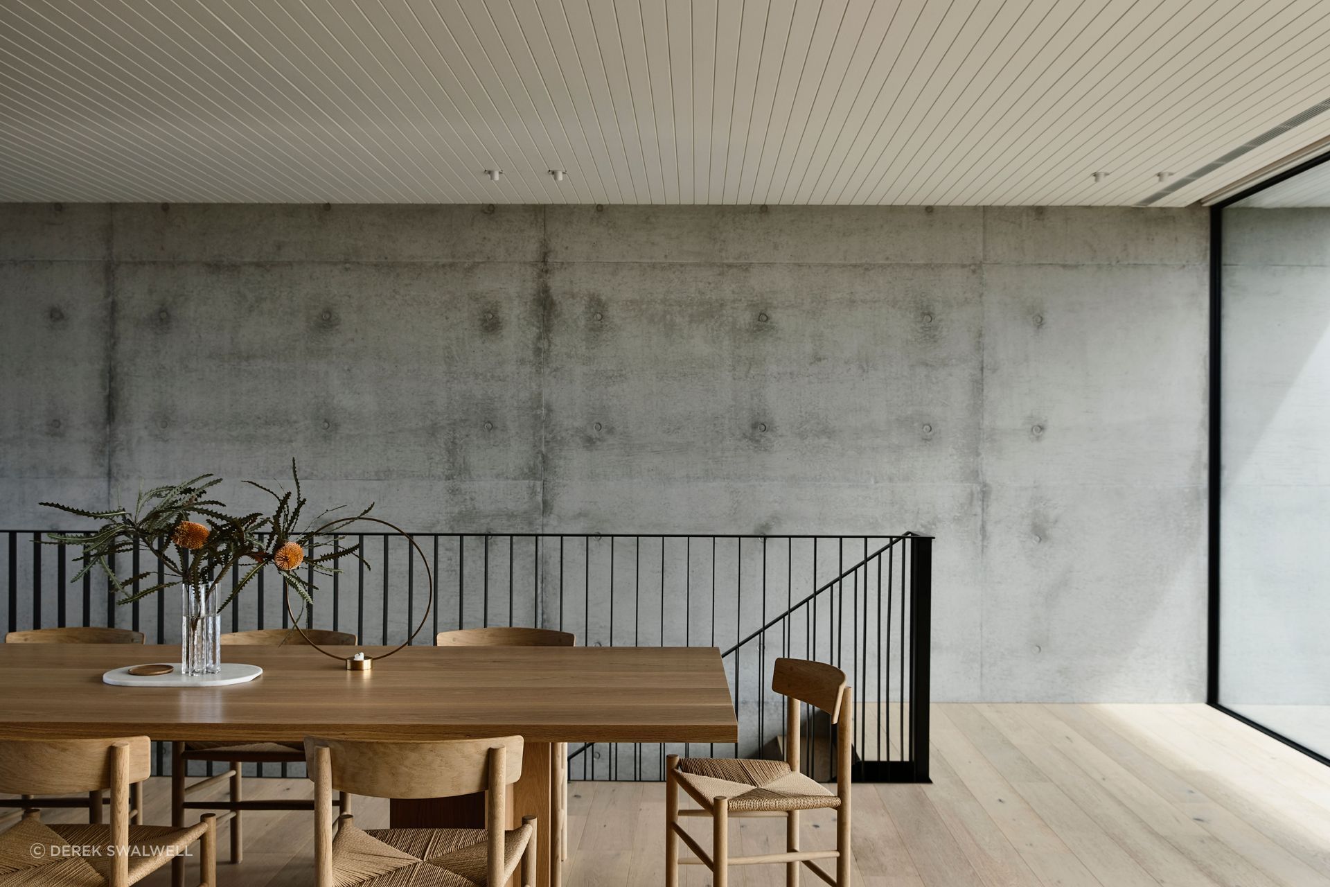 Pale timbers contrast against robust concrete structural elements.