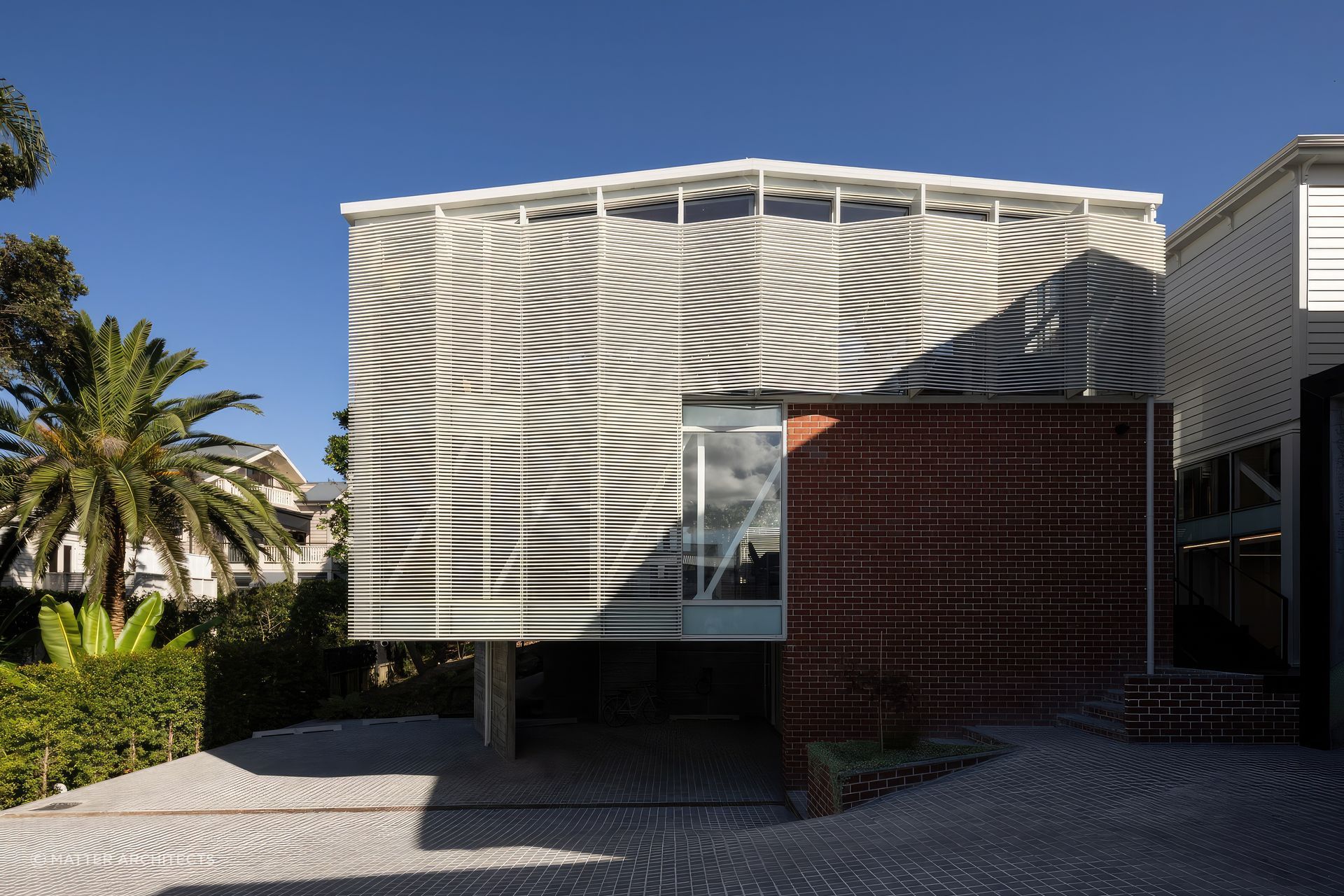 By carving into the earth beneath the original villa and constructing in-situ off-form concrete walls, Jonathan created a solid pedestal base for a three-level, cantilevered extension set a half-height below the villa.