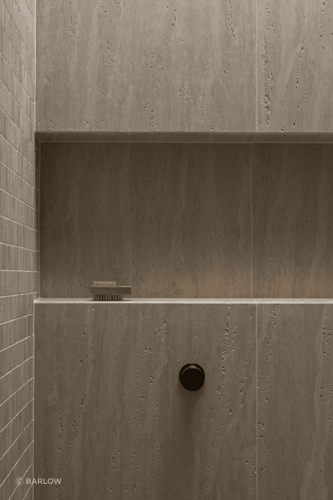Beautiful and textural, the neutral tiles add sophistication to the small space.