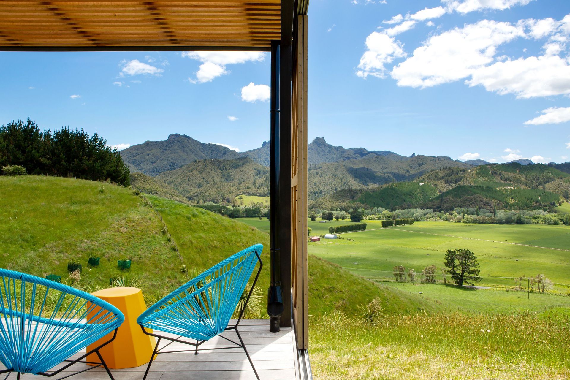 A cedar batten ceiling conceals a translucent roofing sheet above the deck that allows dappled light into the area when the sun is high. 
