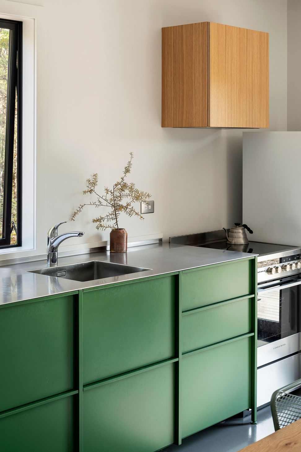 The kitchen is simple and functional, defined by the TKO cabinetry.