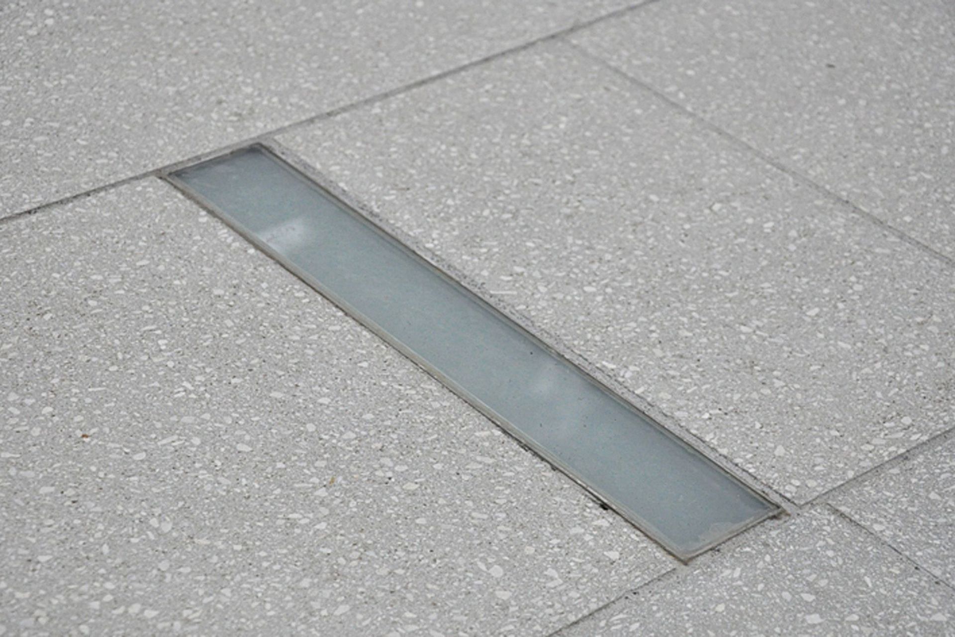 Inground slot shaped LED lighting was custom designed and manufactured for this Khandallah courtyard garden  
