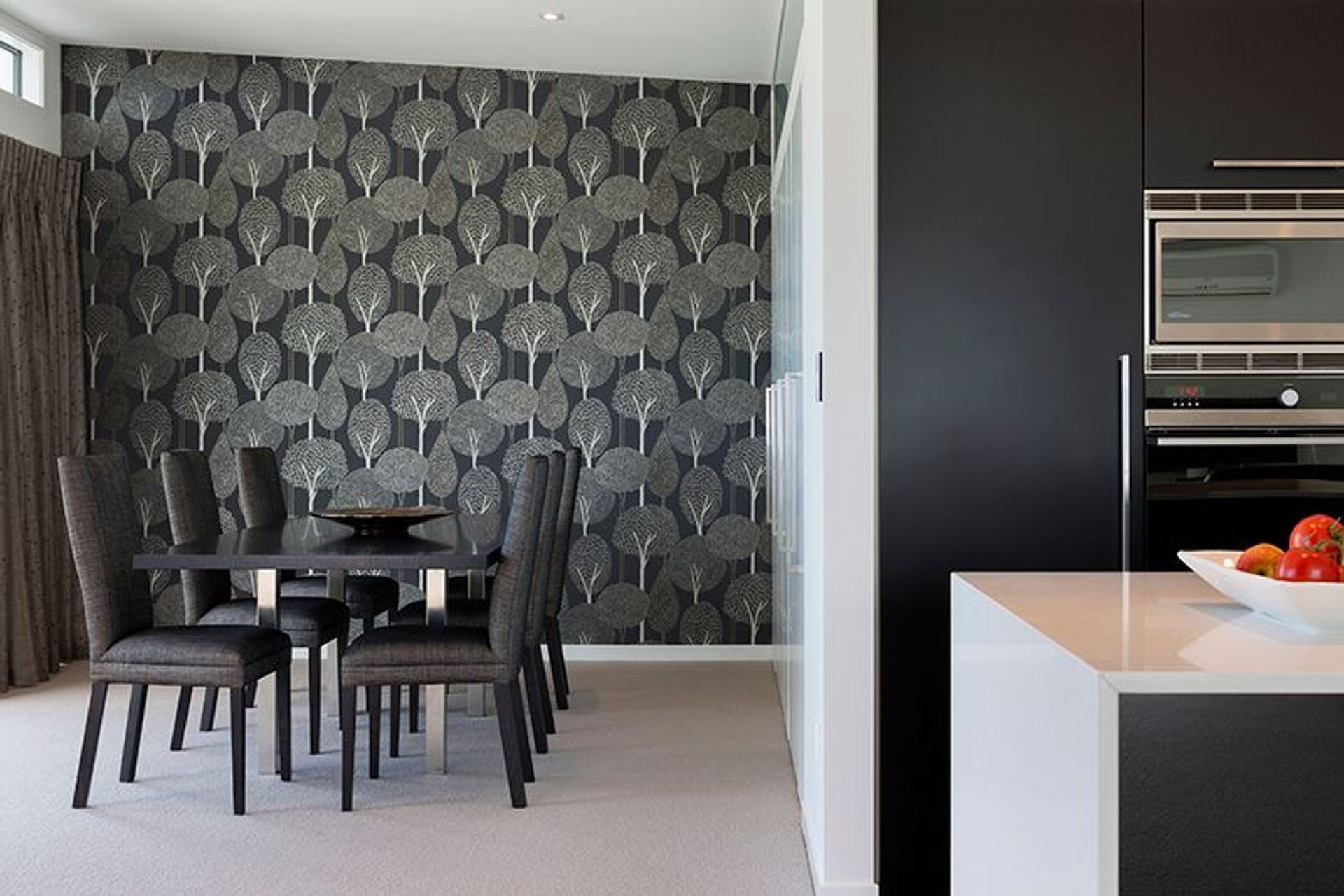 Dining room features Harlequin wallpaper and David Shaw dining chairs. Office space concealed behind bifold doors to the right 