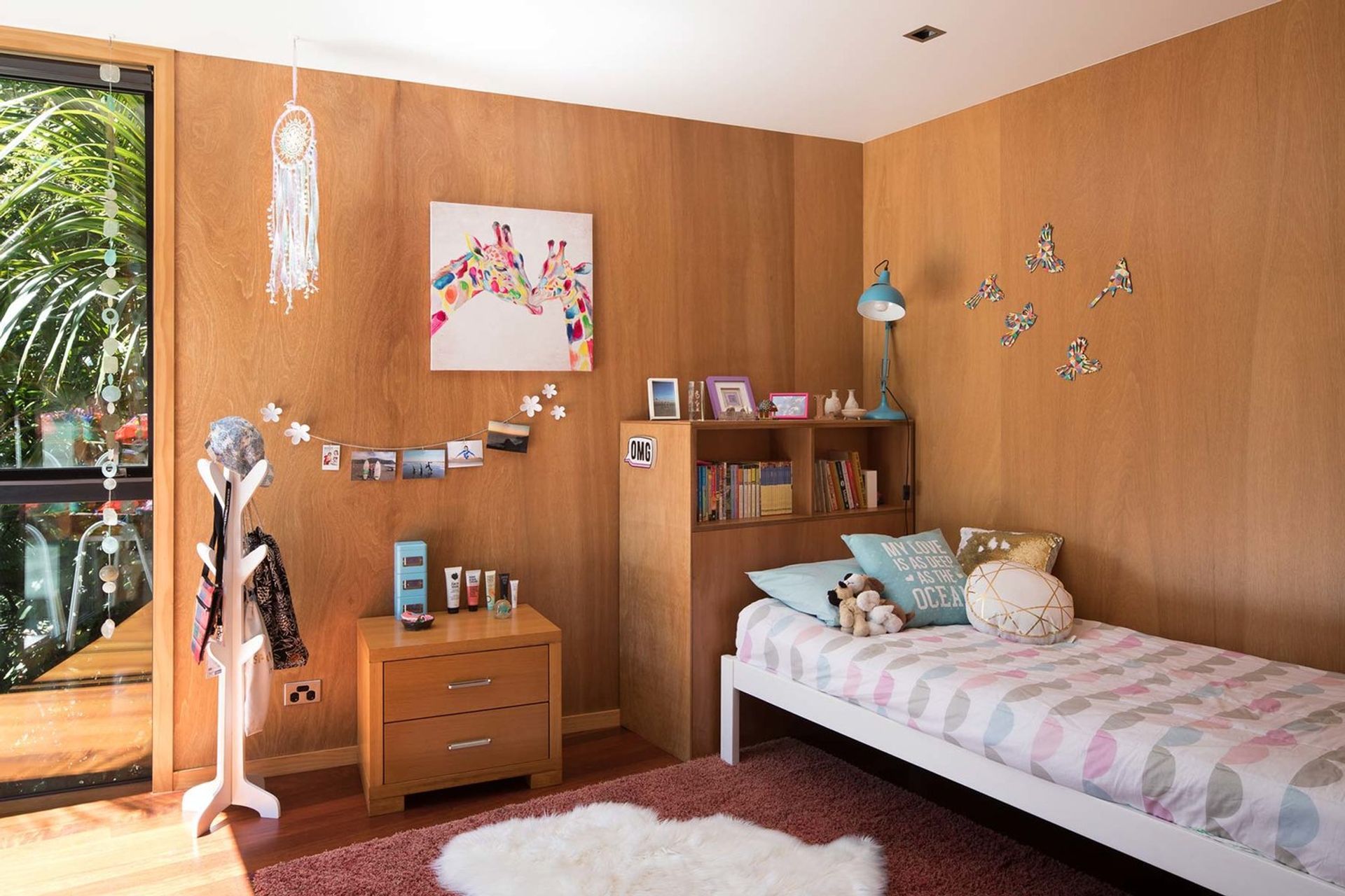 Floor-to-ceiling windows provide light and a healthy environment in bedrooms, while the plywood walls can be matched with relatively clean, simple furniture.  