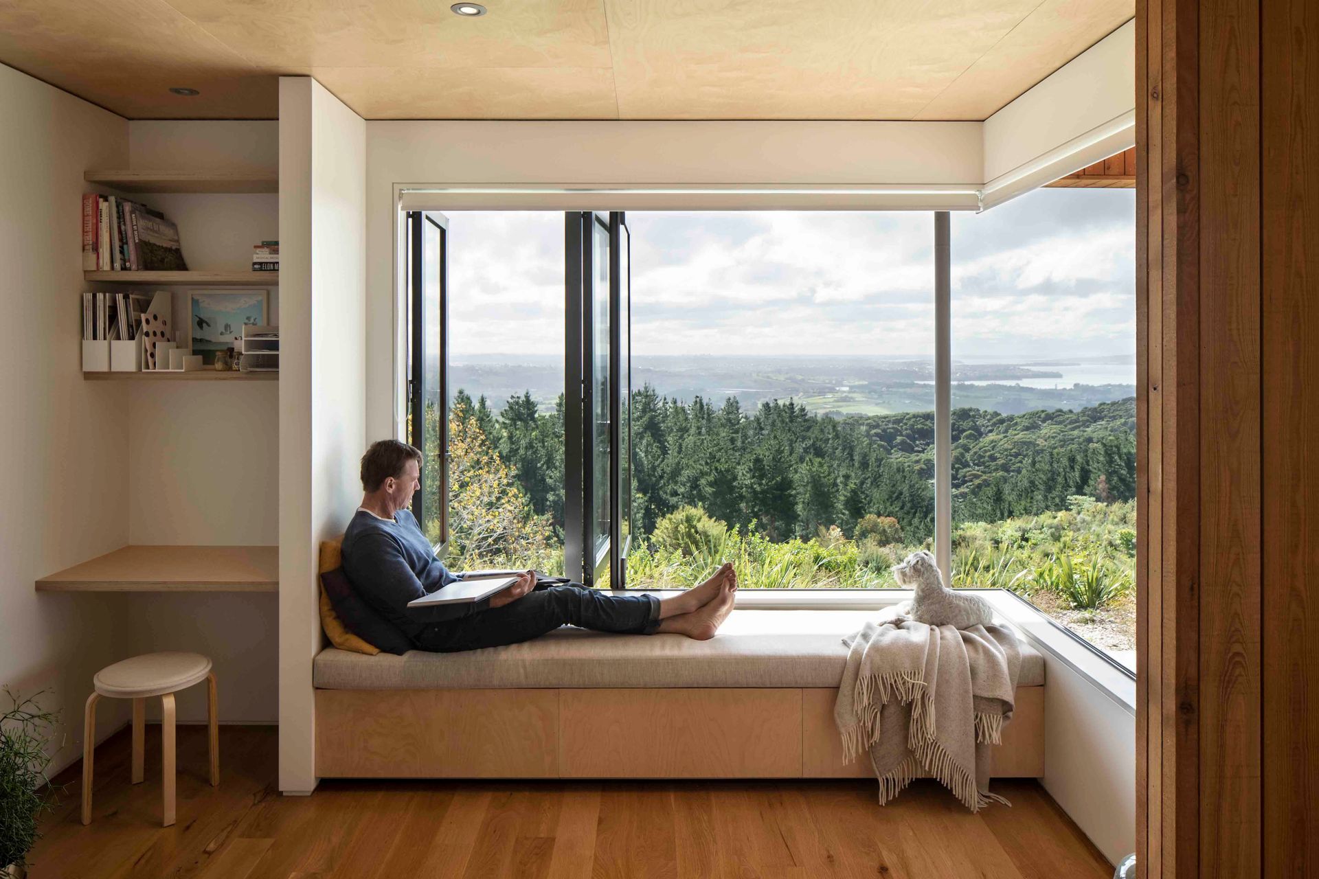 The living room features a window seat - the perfect spot to stop and enjoy the setting.