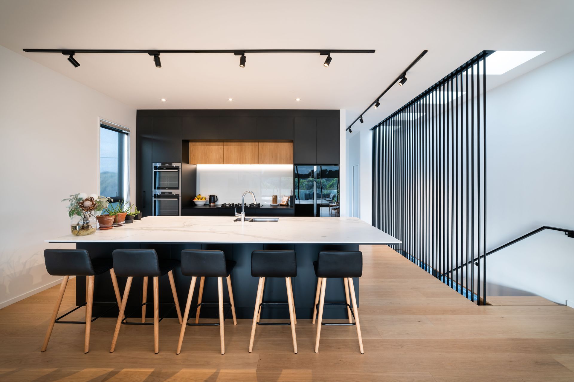 Upstairs, the palette pares back with an open-plan area of monochromatic hues coupled with a timber floor. 