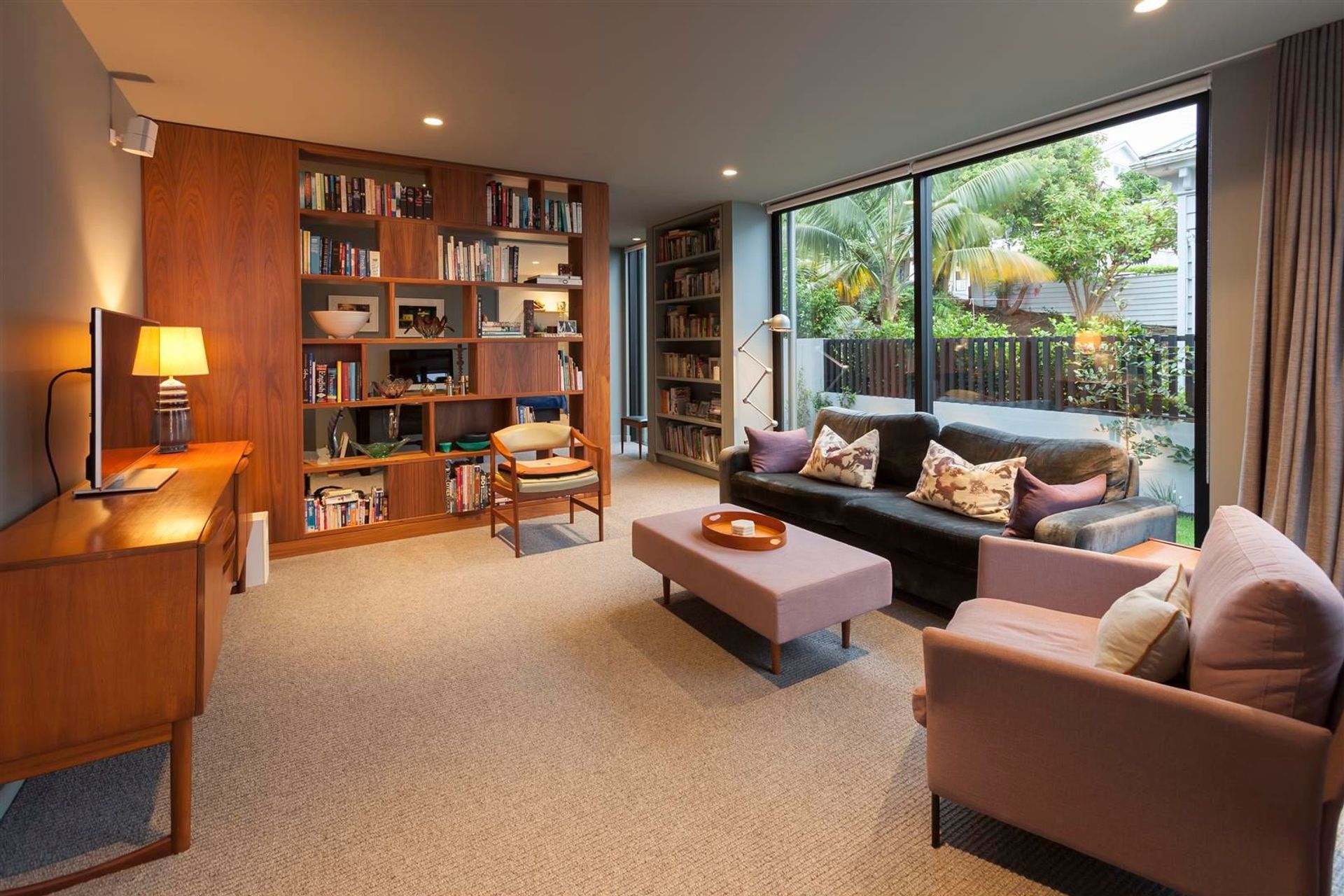 In the second living area the feeling is one of warmth and comfort, the lower ceiling height, timber accents and plush carpet all work together to create a sense of relaxed luxury.