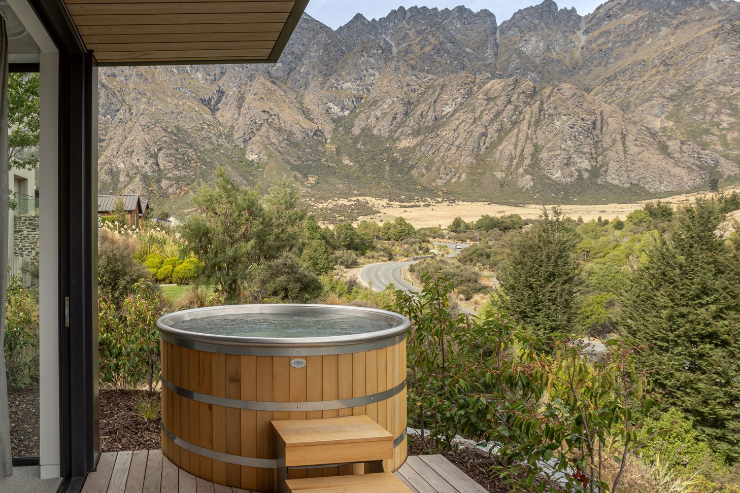 Master bedroom and ensuite both open to a secluded private deck and spa with epic mountain views