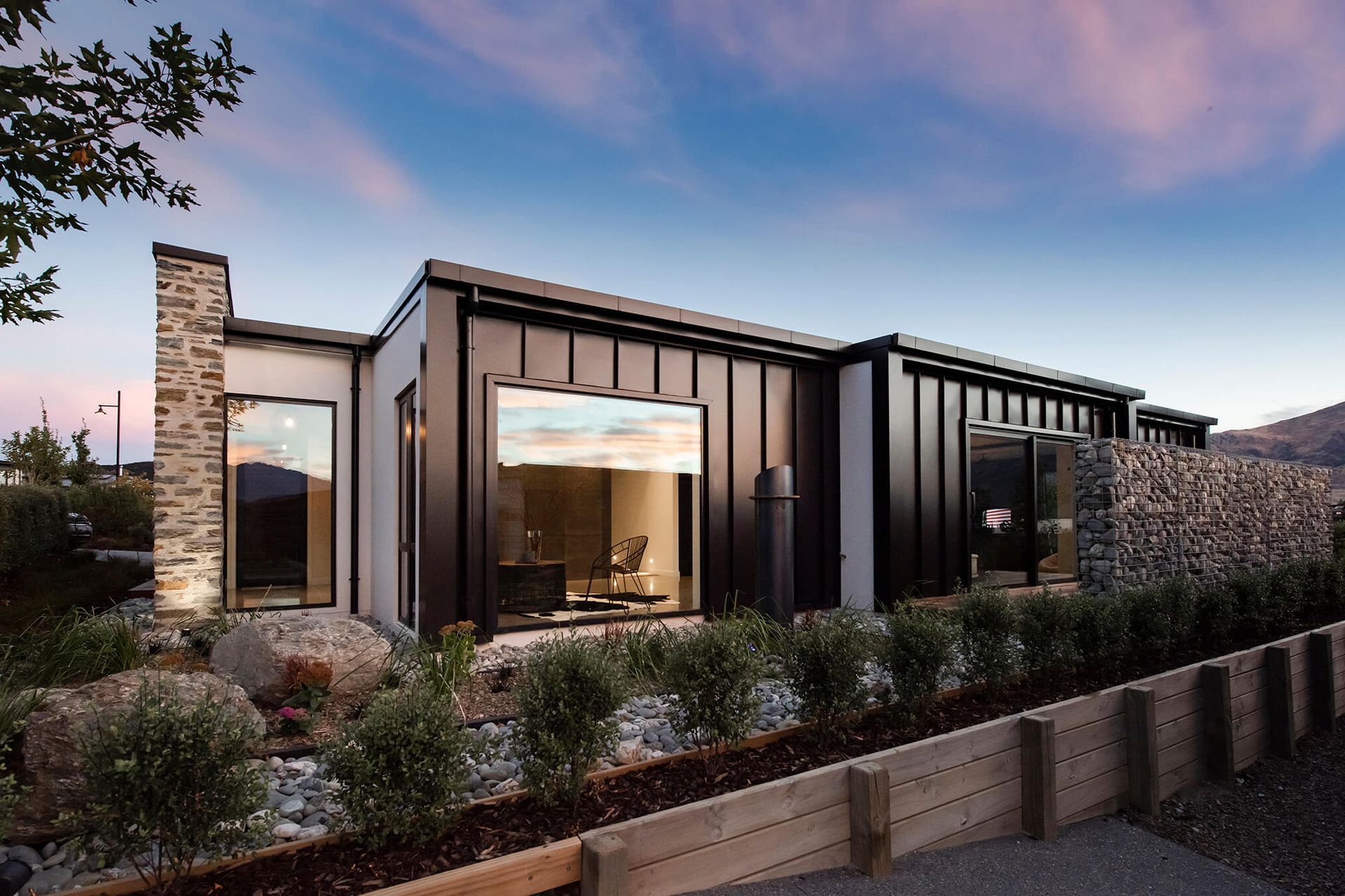 The schist wall anchors the home to the land and the landscape.