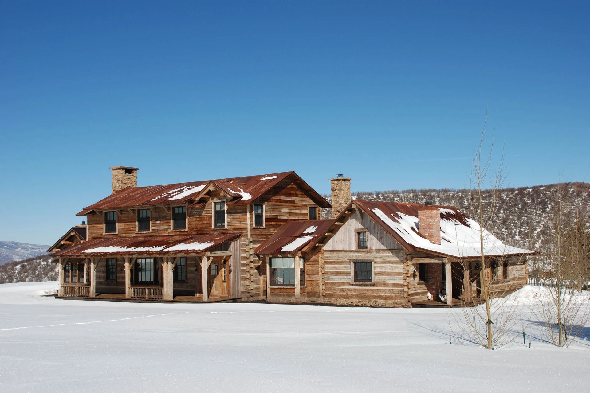 mt-sopris-ranch-rustic-log-home-exterior-winter-colorado-ap-compressed.jpg