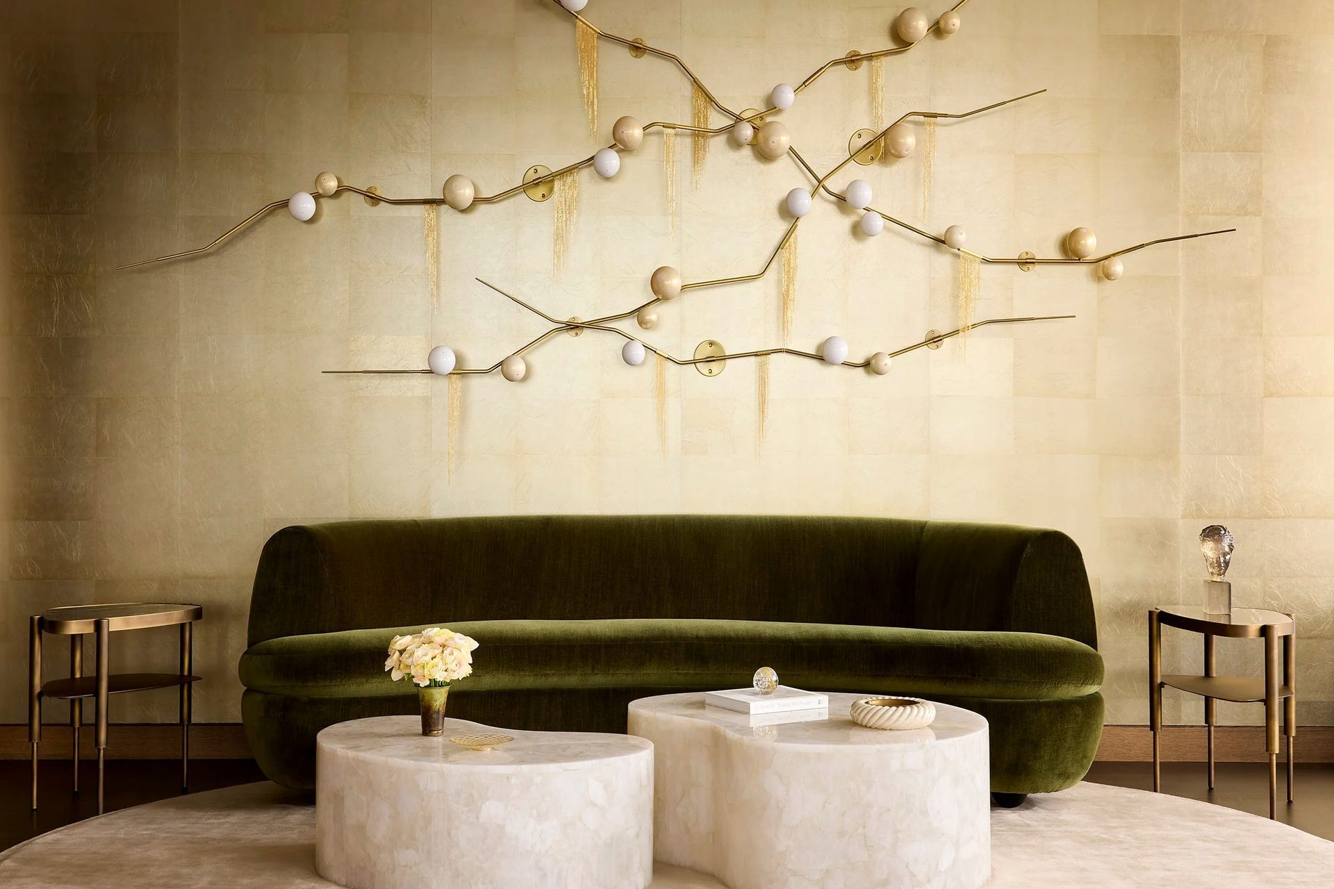 east-river-penthouse-green-velvet-sofa-brass-wall-sculpture-stone-coffee-tables-ap-compressed.jpg