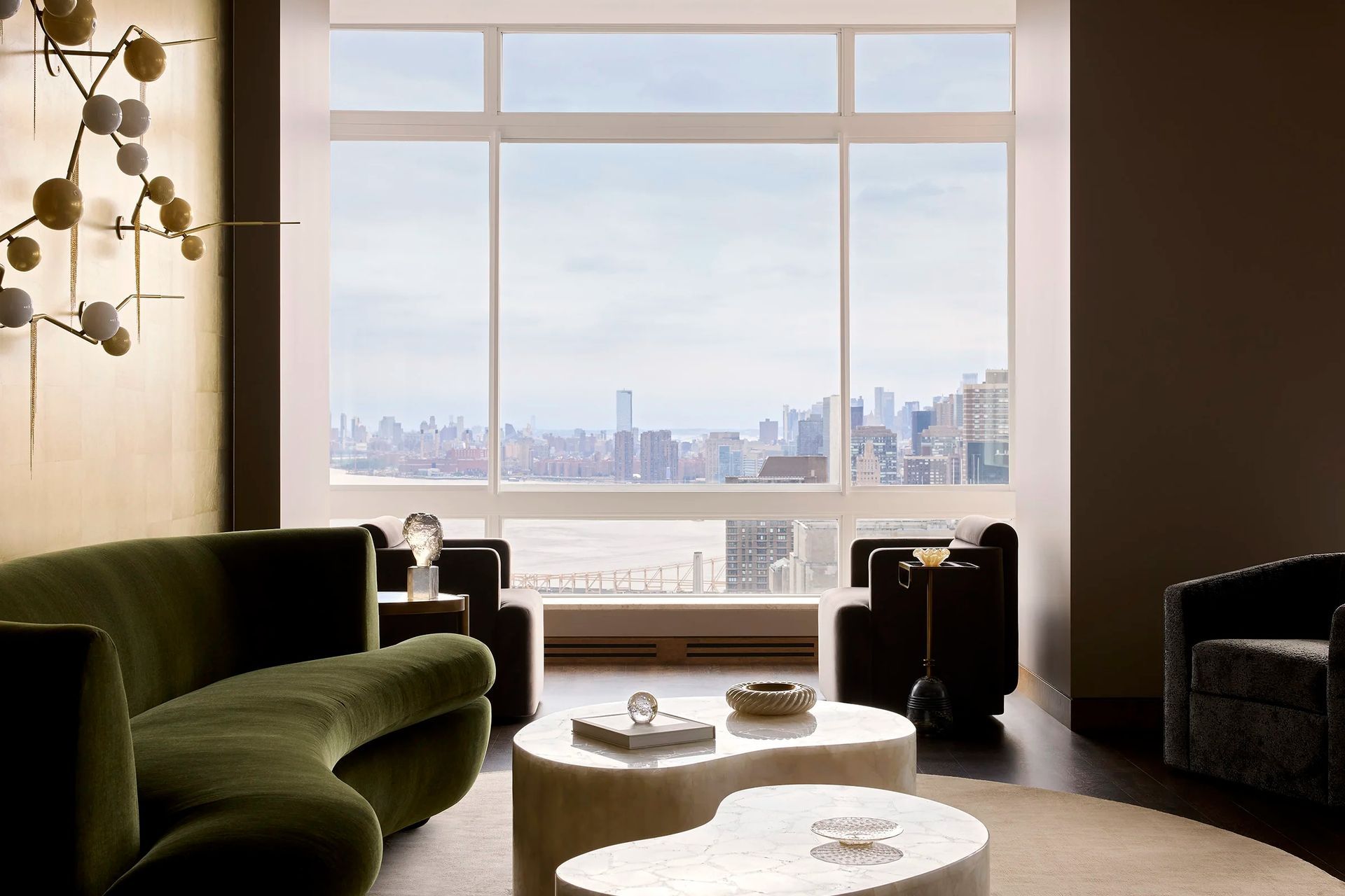 east-river-penthouse-living-room-green-velvet-sofa-city-view-ap-compressed.jpg