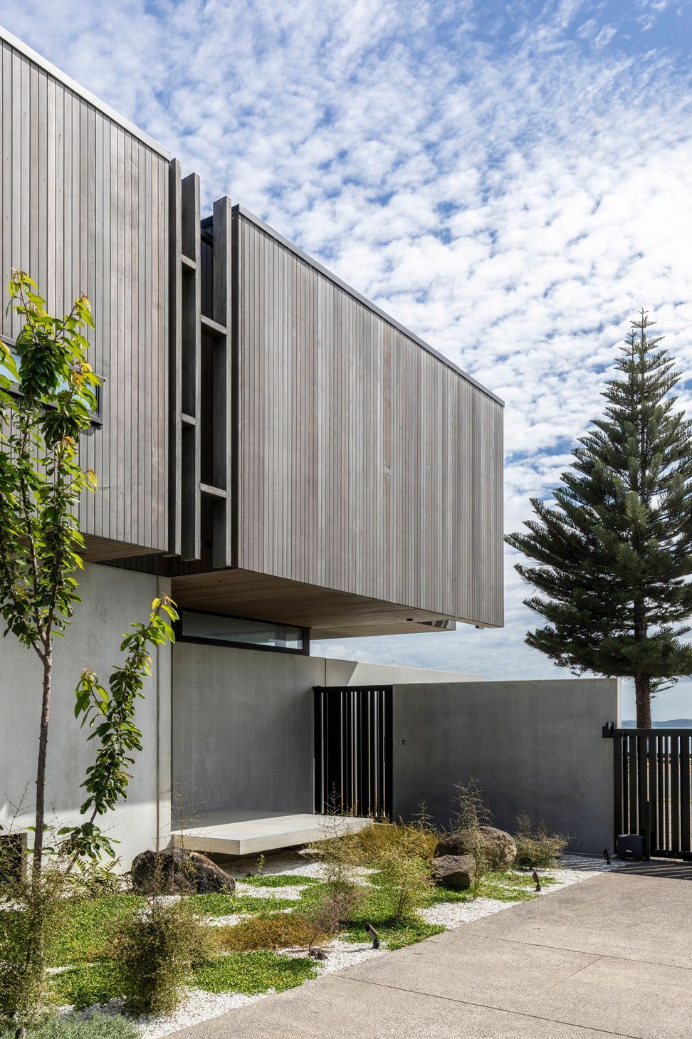The entry gate opens to a private landing space, before entering the house through the front door.
