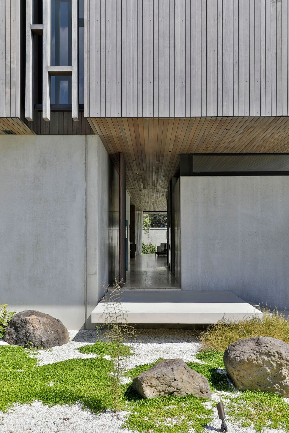 The front door leads visitors directly down a hallway to the living spaces.