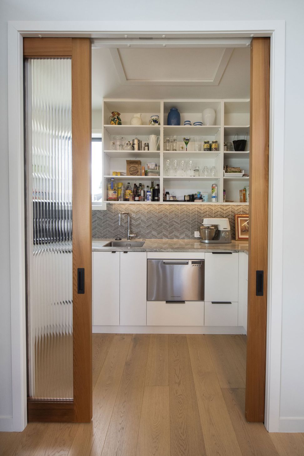 Reeded glass doors into walk in pantry
