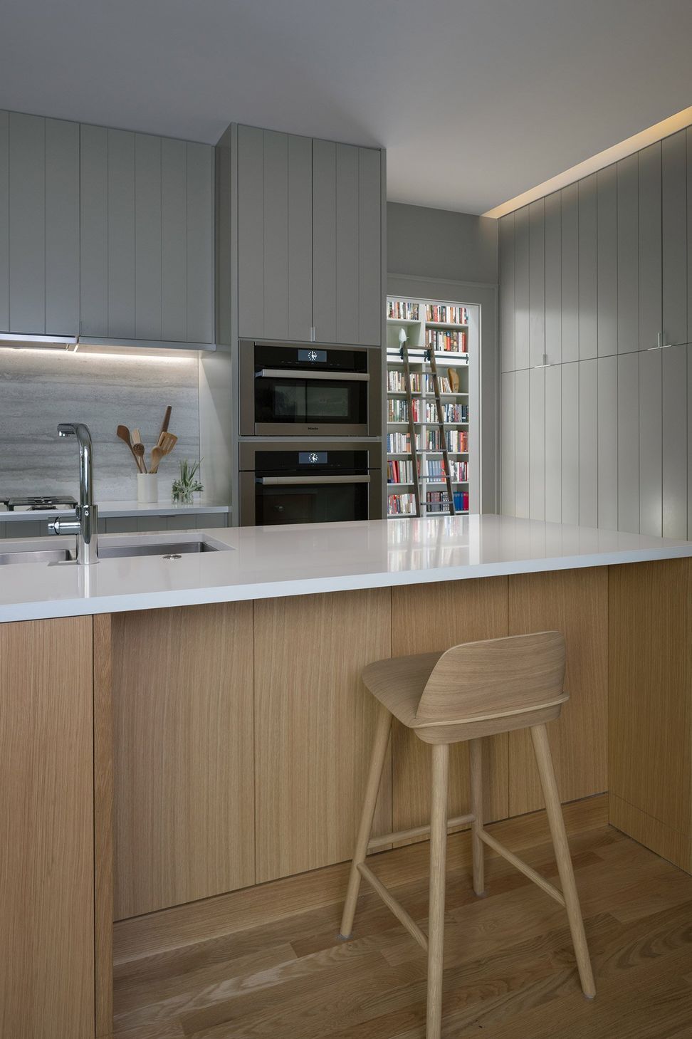 8HeritageOakCottageCuppettKilpatrickArchitectureandInteriorDesignaustin-tx-modern-kitchen-island-vertical-storage-hidden-millwork.jpg
