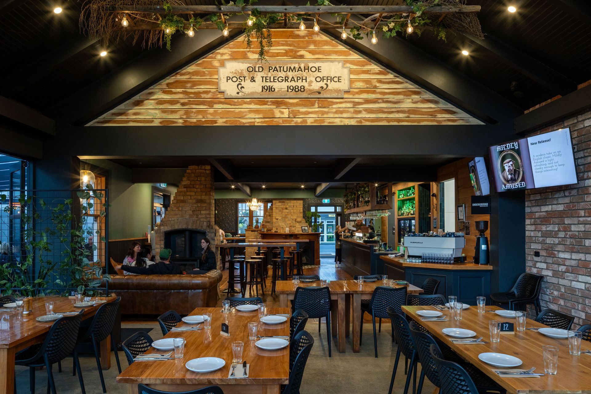 All new addition in black steel with large doors to outdoor dining spaces. Original brick chimneys and polished timber floors are retained.