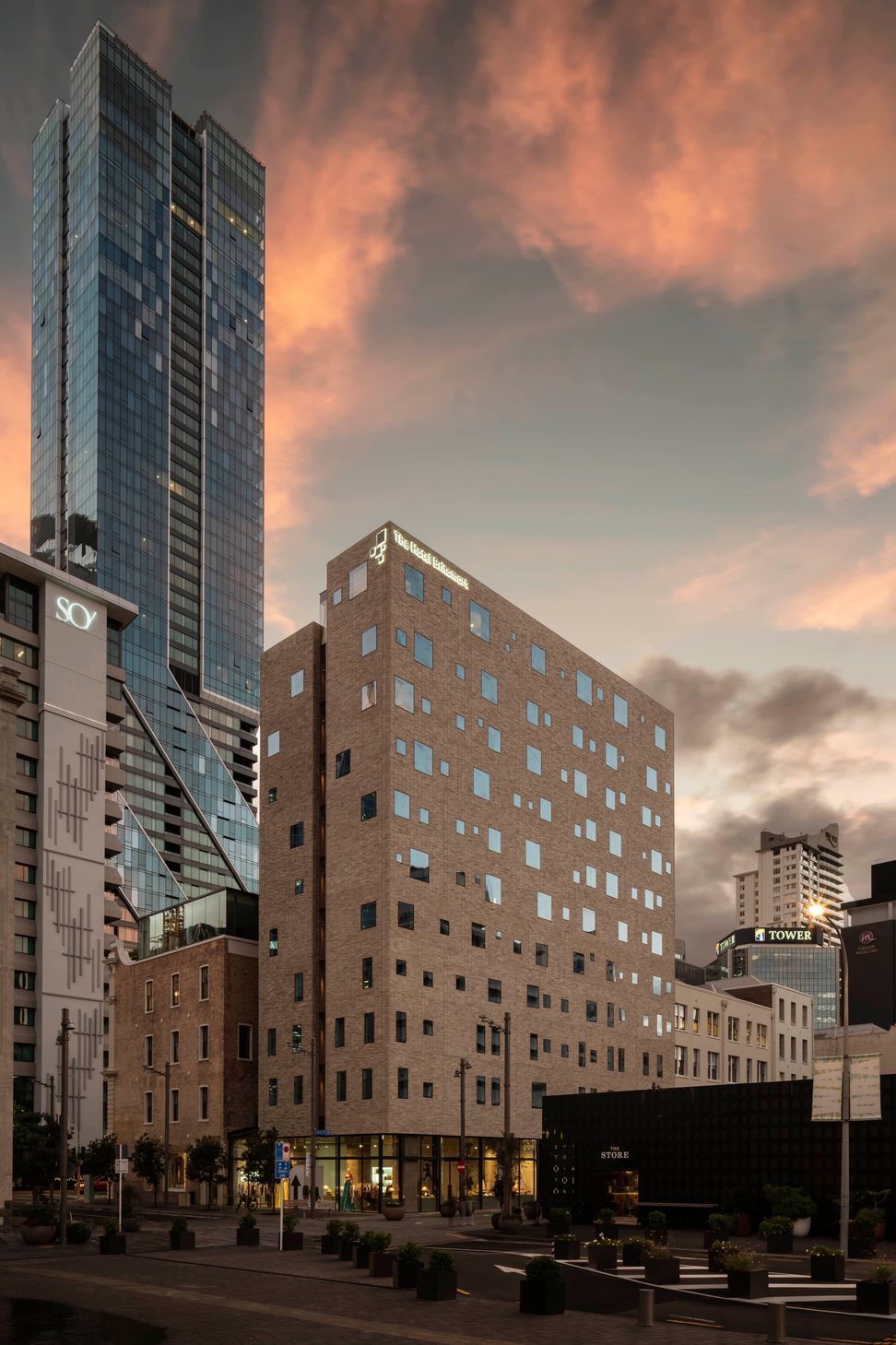 The Hotel Britomart's full brick facade is floating on a glass podium.