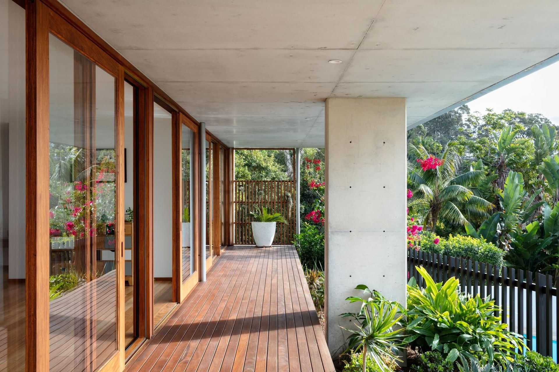 15-Matt-Day-Architect-Matt-Day-Bayview-House-Ground-Floor-Timber-Deck-Concrete-Column-Timber-Sliding-Doors.jpg