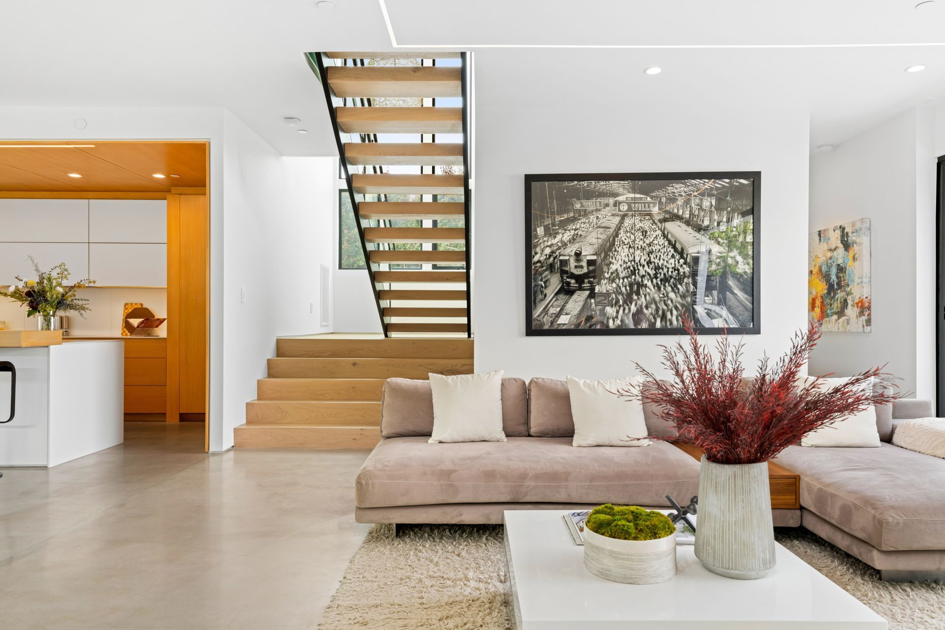 The family residence now features an open floor plan, with the kitchen flowing directly into the living area. The stair’s open treads allow light to spill through, brightening the interiors.