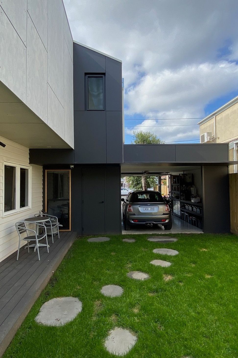The garage provides privacy to the side garden and can be used as a space for entertaining