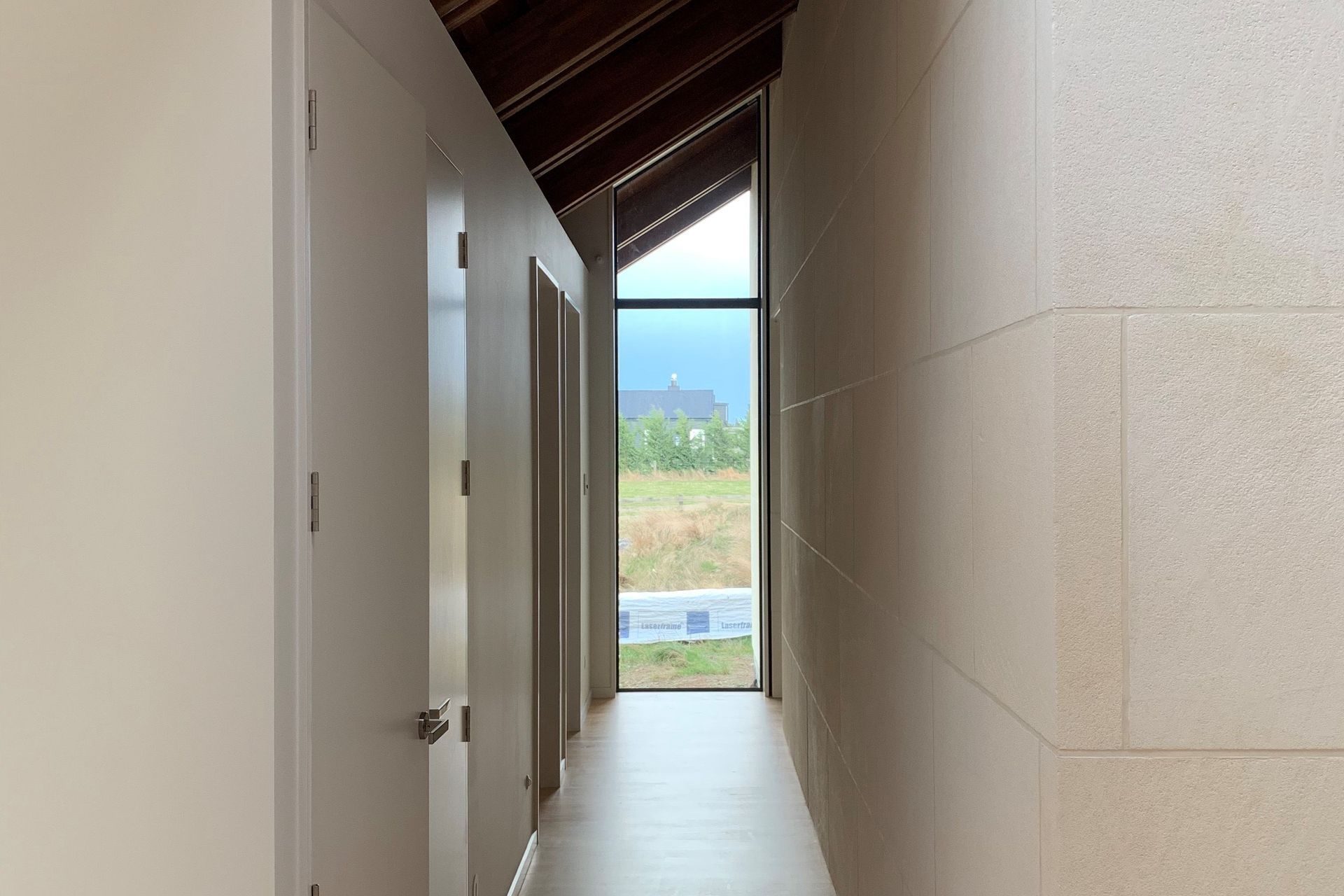 Interior limestone wall. Ōamaru stone sawn faced finish in a custom size.