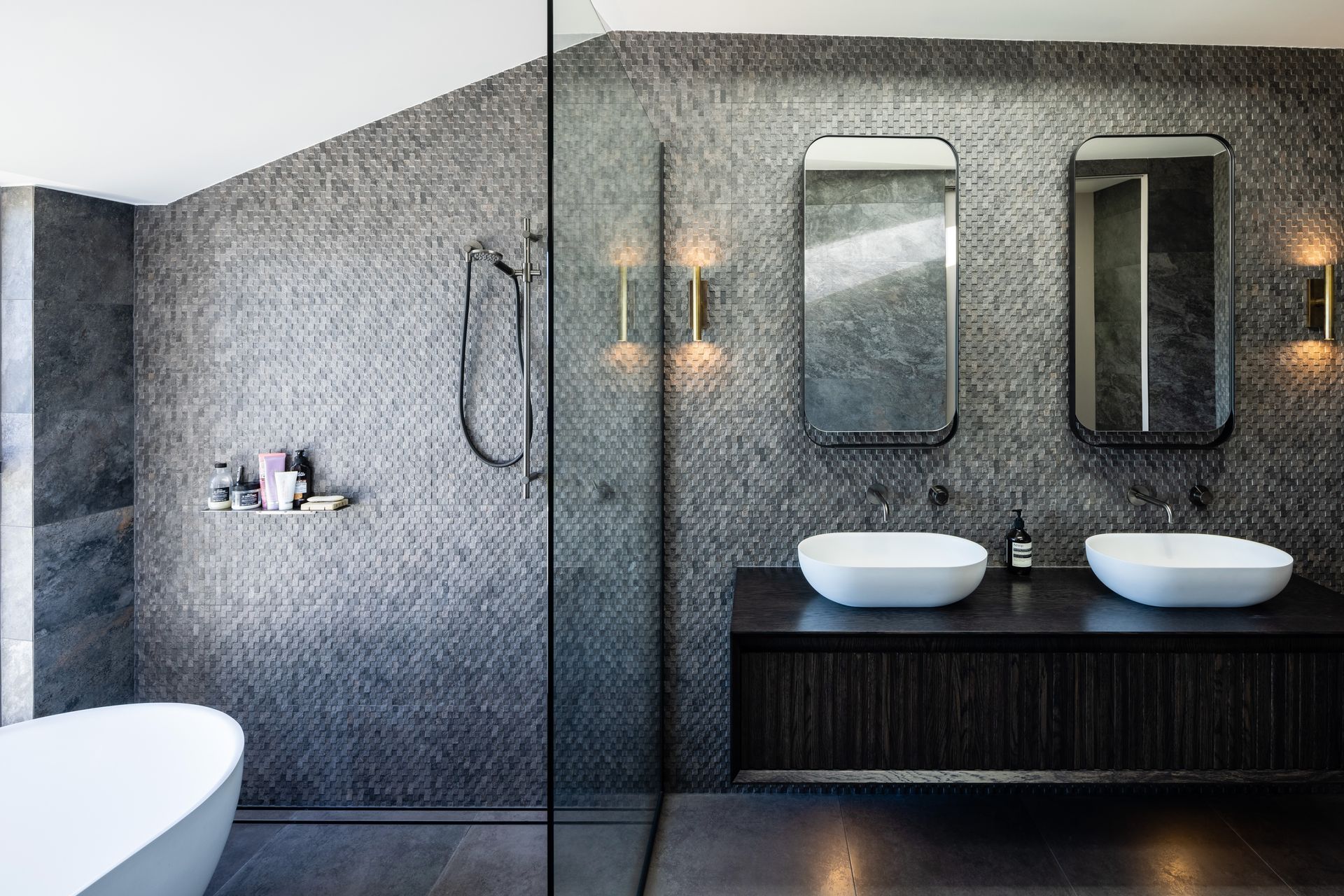 The floor-to-ceiling tiles of the master en suite create a clean but dramatic feeling.