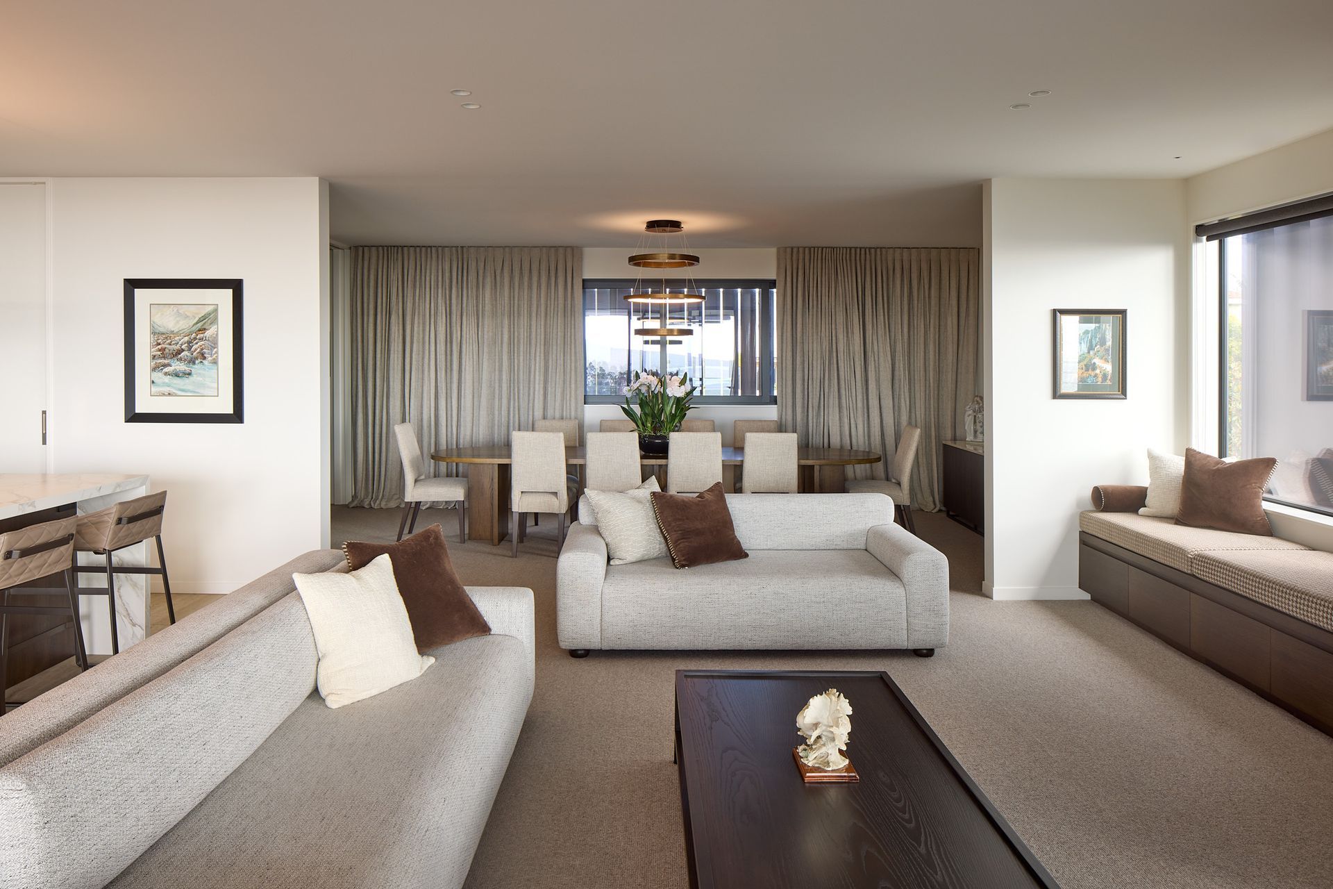The open-plan interior is organised around generous kitchen, dining and living spaces designed for contemporary family life. A calm material palette and carefully selected furnishings create a refined backdrop to the expansive coastal outlook.