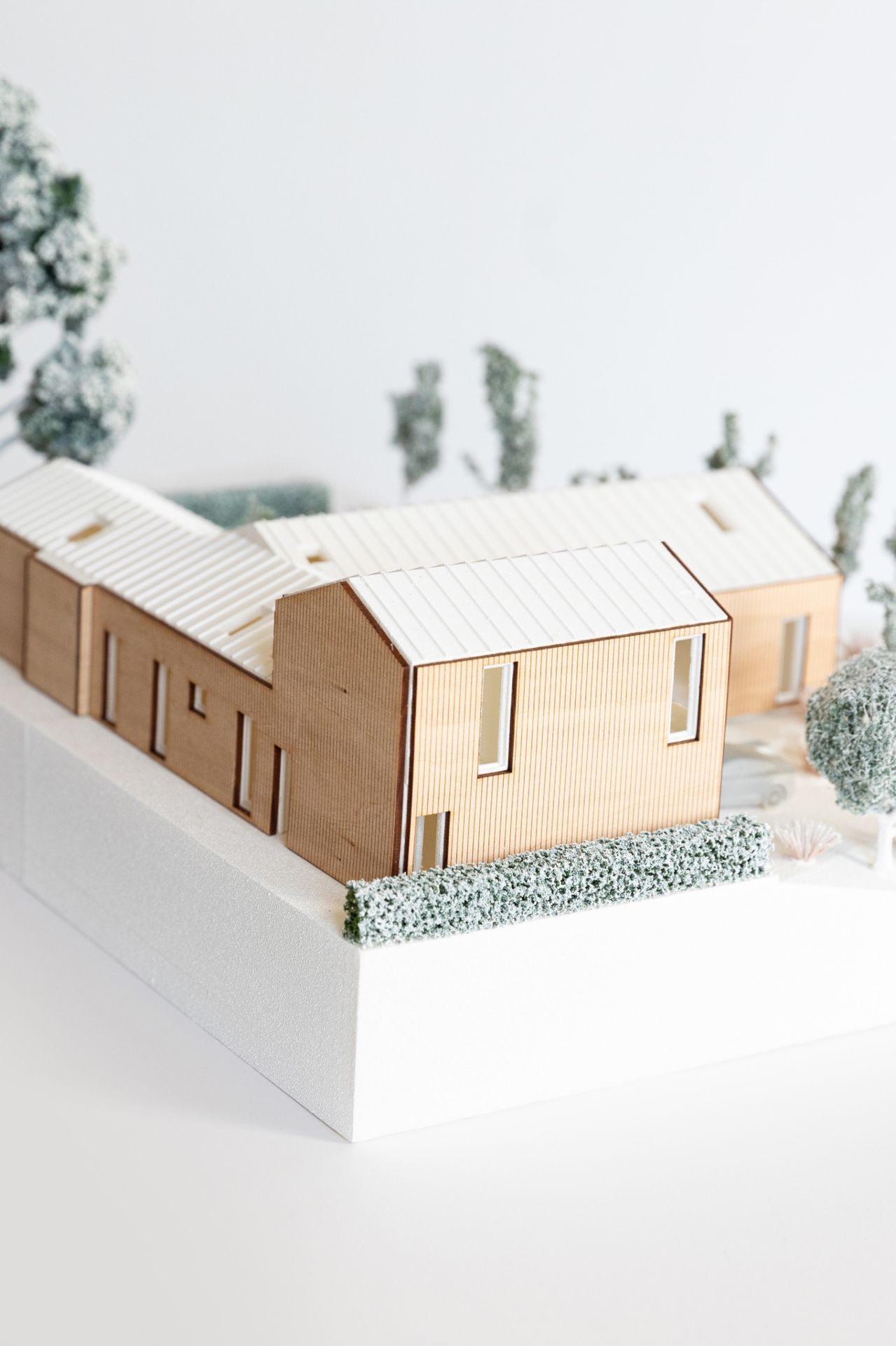 The plan for the farmhouse-inspired home forms a “T” shape that includes a garage topped with
an ADU.