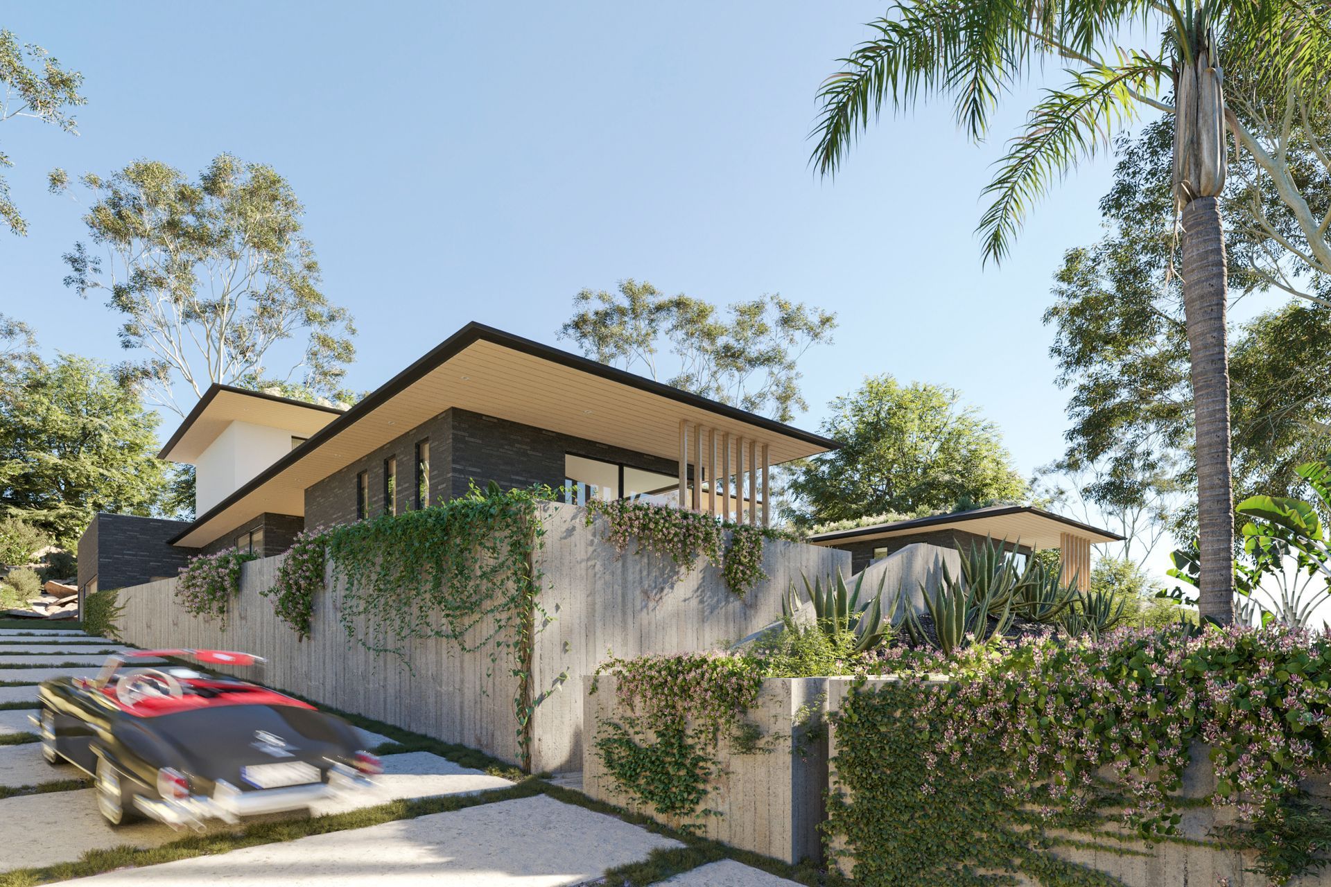 Large-format patio pavers and board-formed concrete walls covered in lush plants form the home’s entry sequence.