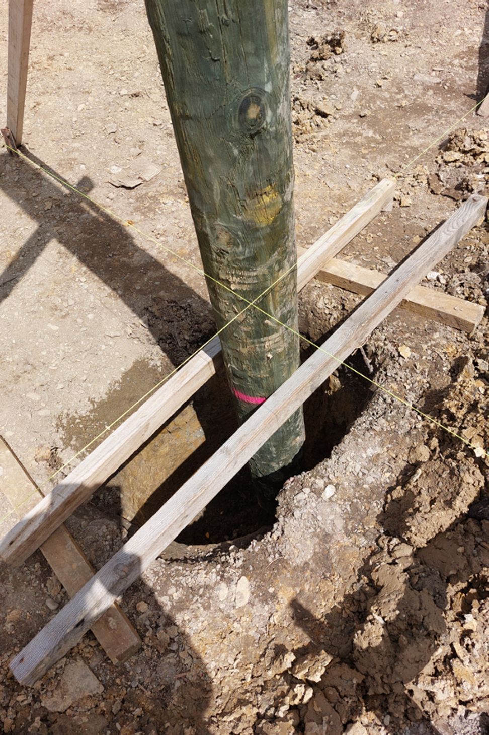 Support for poles whilst waiting for concrete