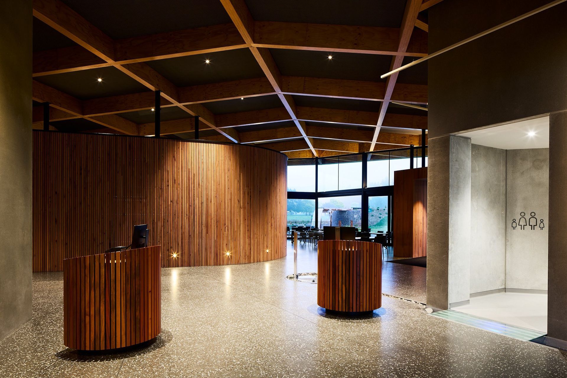 The concrete floor of the interior is composed of local aggregate, and leads you on a winding journey through the change rooms out to the pool.