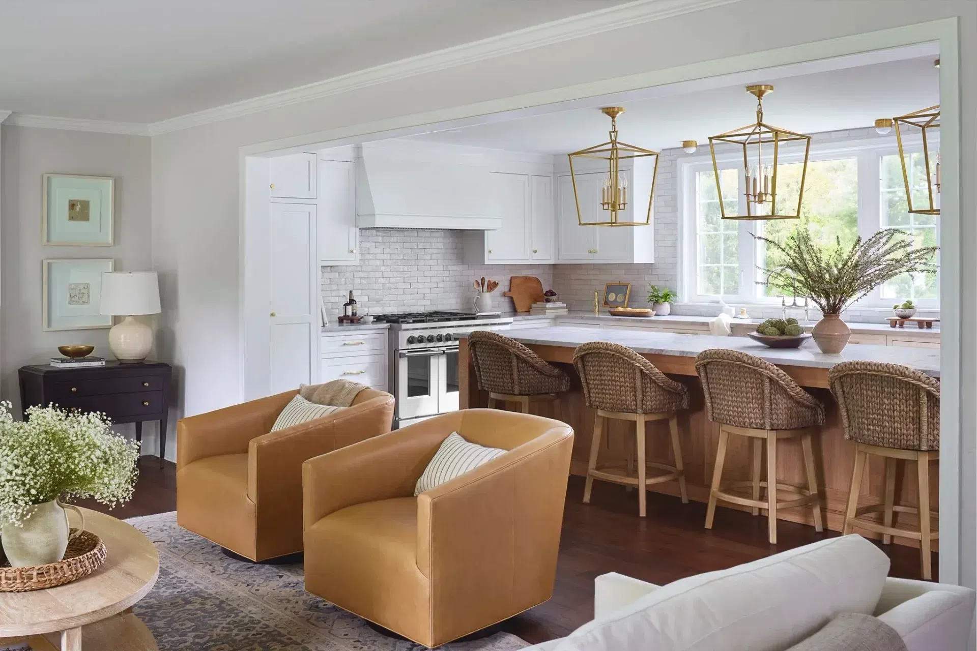 kitchen-renovation-white-cabinets-white-subway-tile-backsplash-bronze-pendant-lights-wicker-barstools-sharp-and-grey-interiors-philadelphia-pa.webp