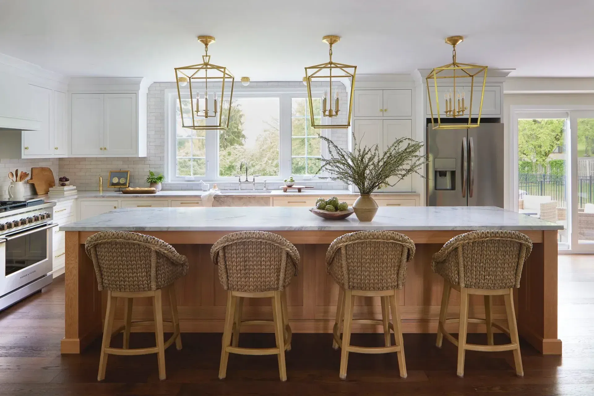 kitchen-renovation-white-wood-cabinets-white-subway-tile-backsplash-bronze-pendants-wood-island-sharp-and-grey-interiors-philadelphia-pa.webp