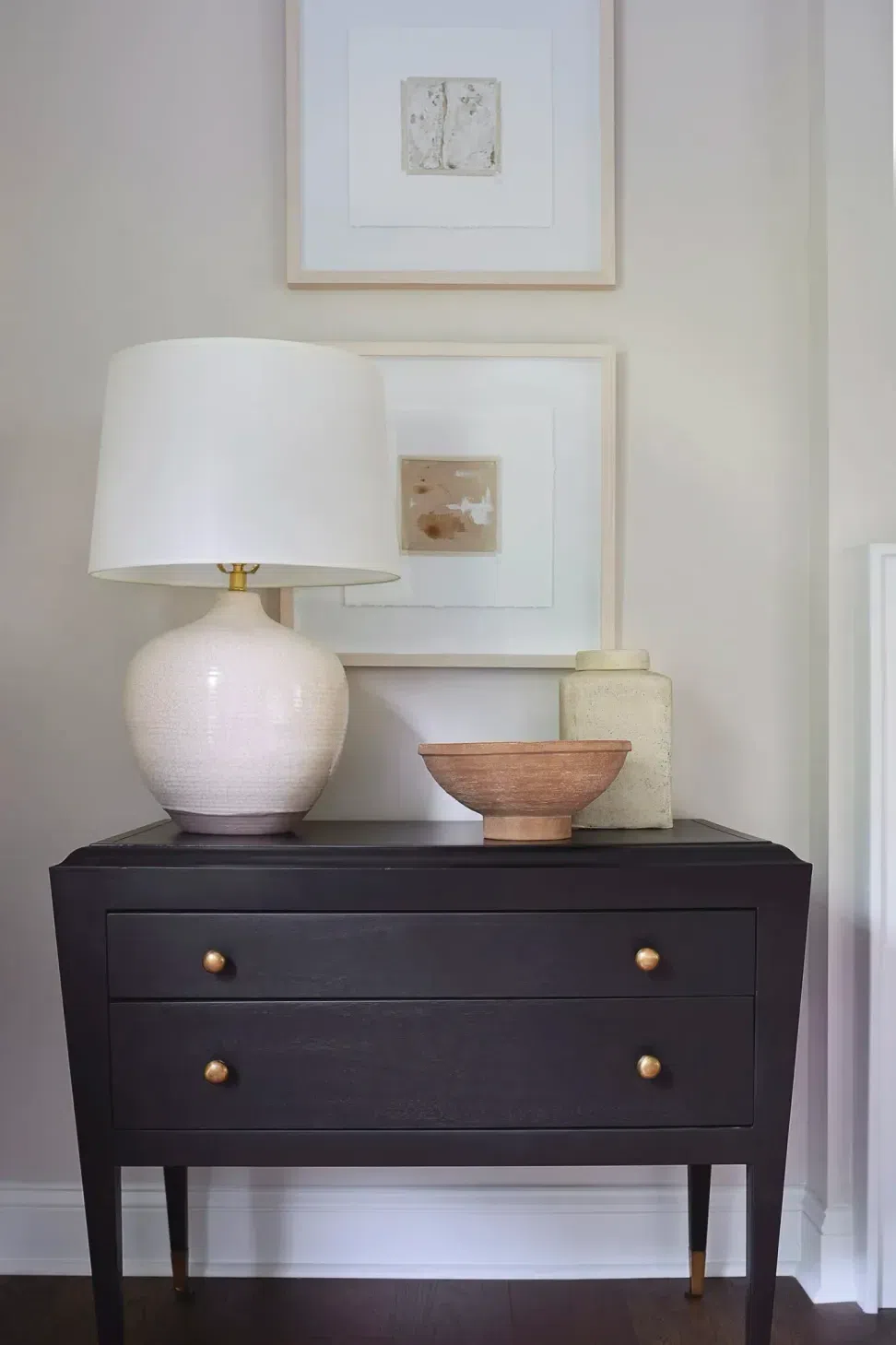living-room-interior-design-black-end-table-bronze-hardware-ceramic-accessories-dark-hardwood-floor-sharp-and-grey-interiors-philadelphia-pa.webp