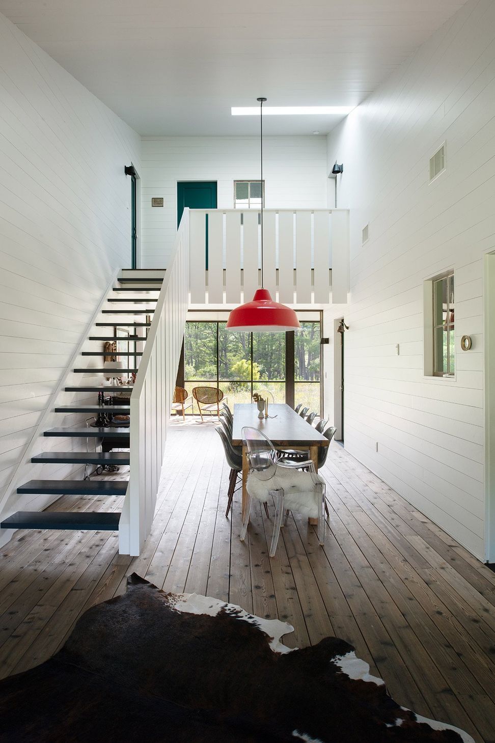 11CampFrioCuppettKilpatrickArchitectureandInteriorDesigndining-room-interior-with-minimalist-staircase-and-statement-ligh.jpg