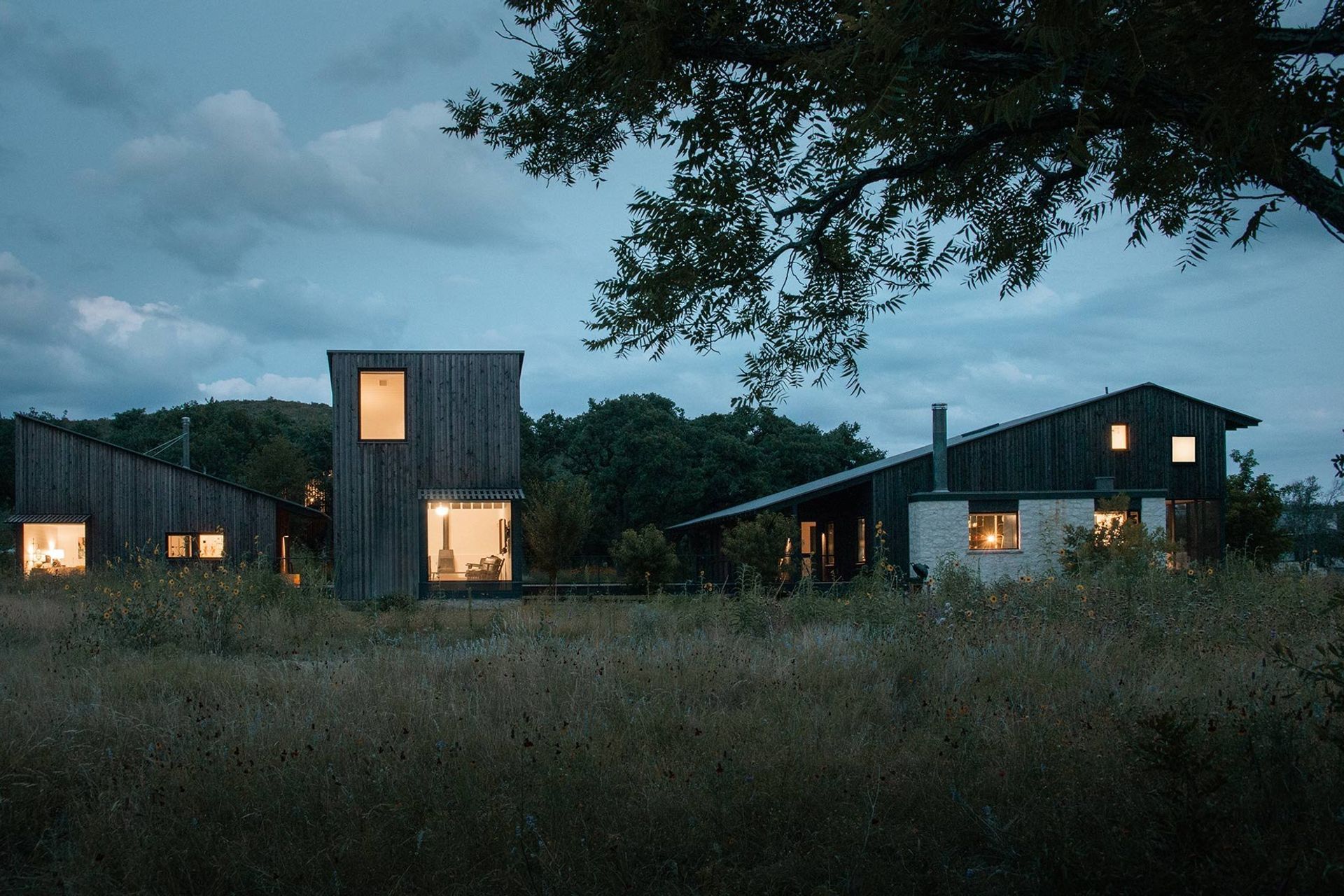 27CampFrioCuppettKilpatrickArchitectureandInteriorDesigndusk-lit-cabins-rural-setting.jpg
