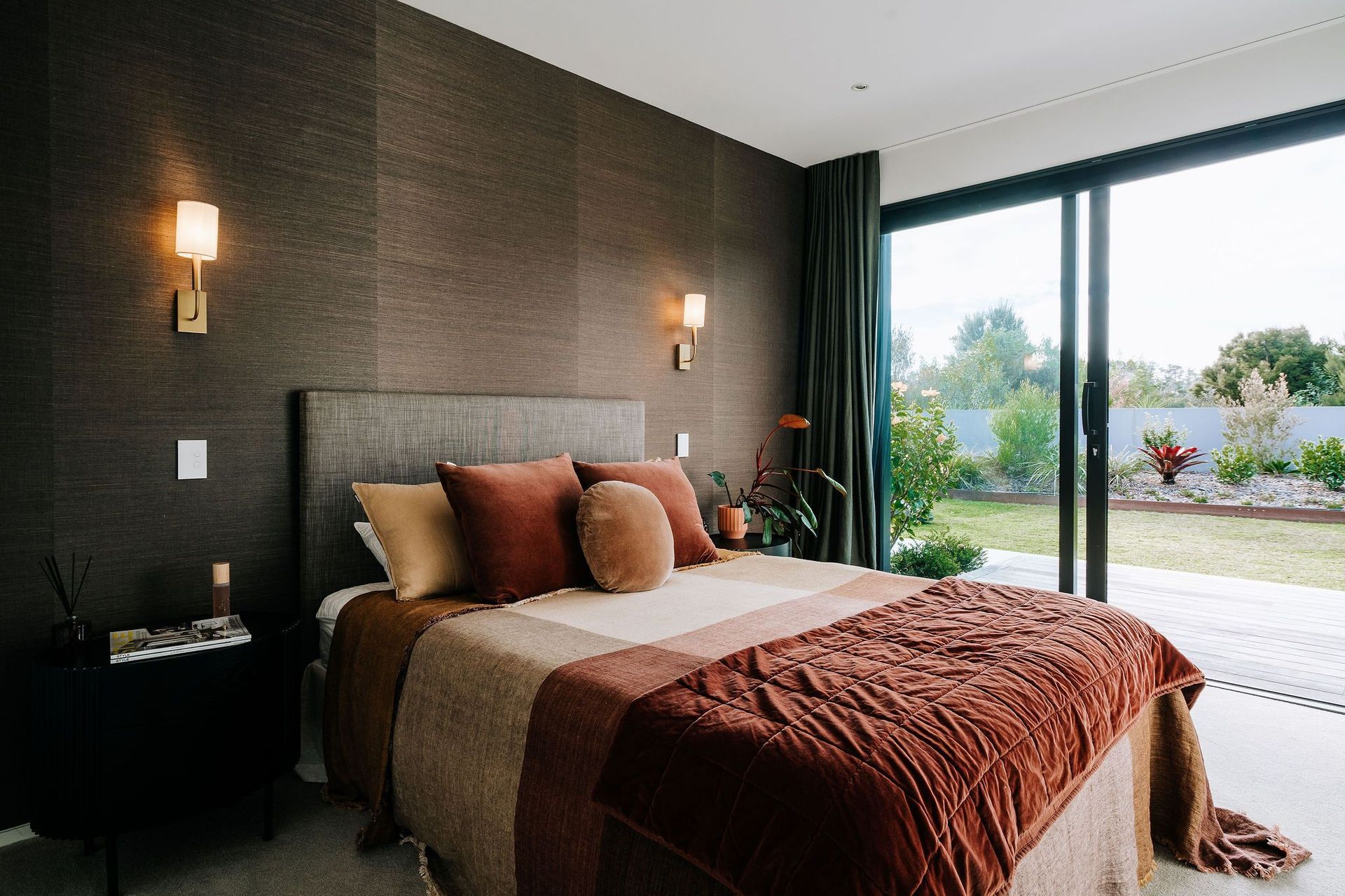 warm-bedroom-wall-lights-bed-throws-red-wallpaper-arcline-architecture.jpg
