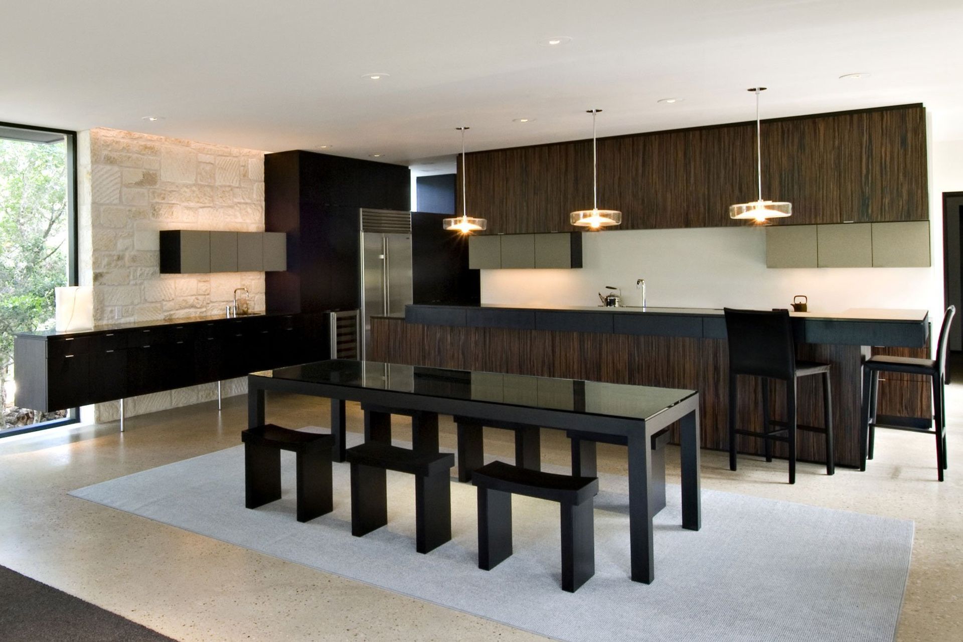 12HouseinTreesCuppettKilpatrickArchitectureandInteriorDesignaustin-tx-modern-kitchen-dining-wood-cabinets-limestone-wall-v2.jpg