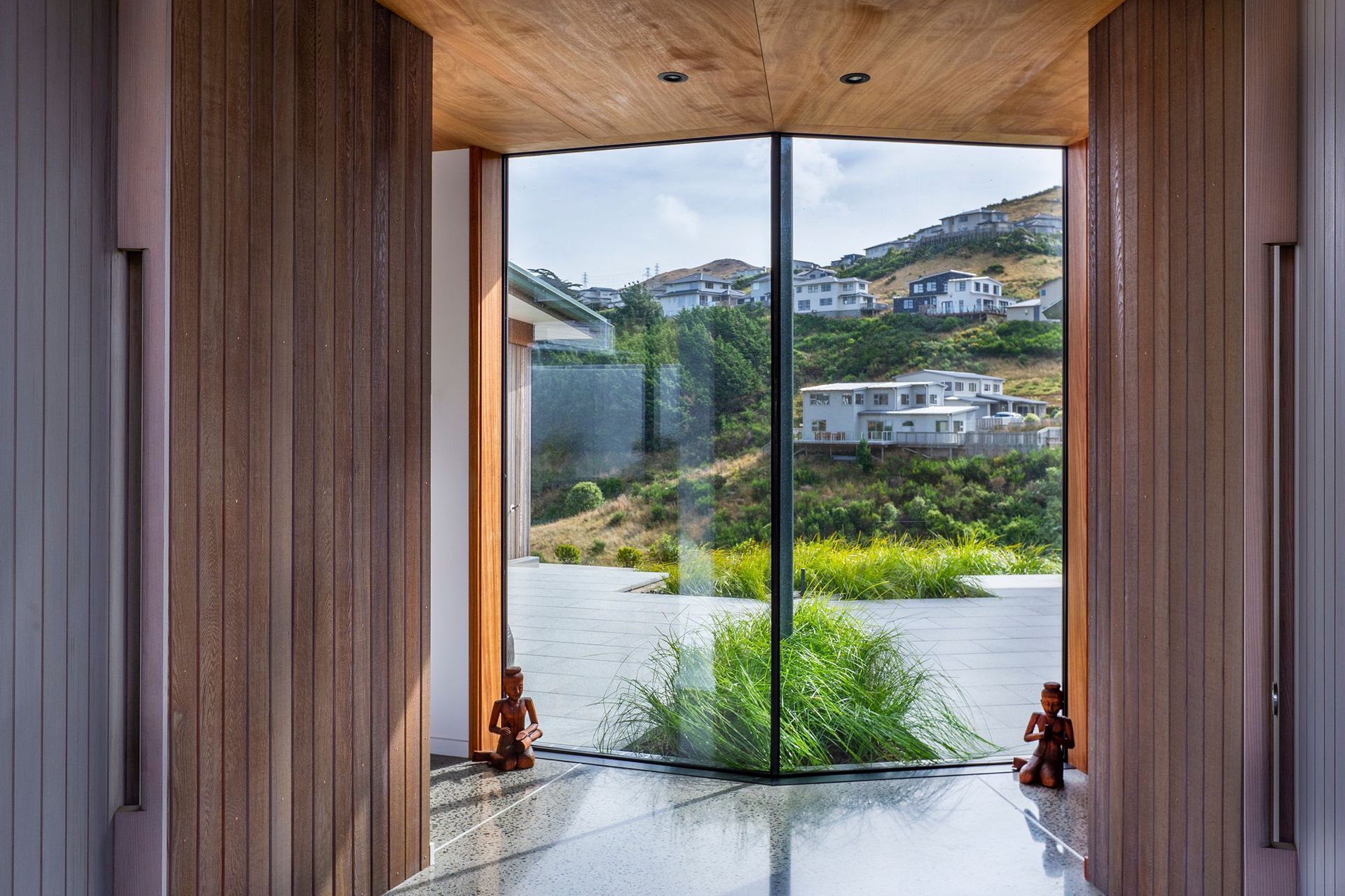 The west-facing site sits between the road and a valley reserve, which has been planted in native planting and also contains the beginnings of the Porirua Stream.