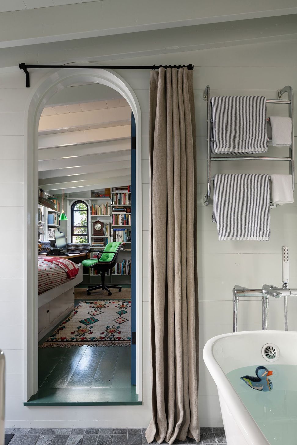 9MarthasVineyardCottageCuppettKilpatrickArchitectureandInteriorDesignarched-bathroom-doorway-view-towards-office.jpg